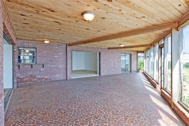 unfurnished sunroom featuring beam ceiling and wood ceiling