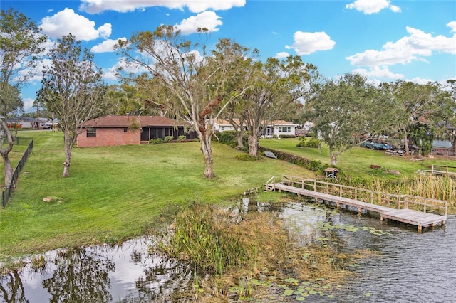 exterior space with a dock and a water view