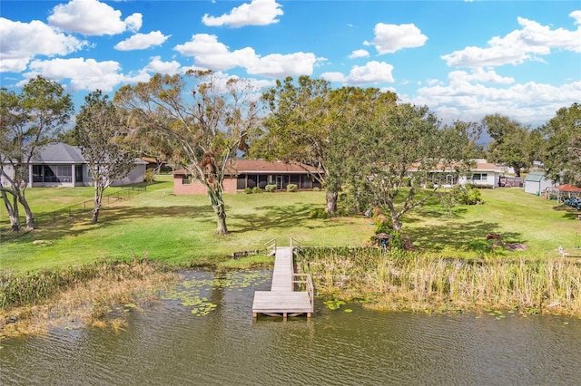 dock area featuring a lawn and a water view