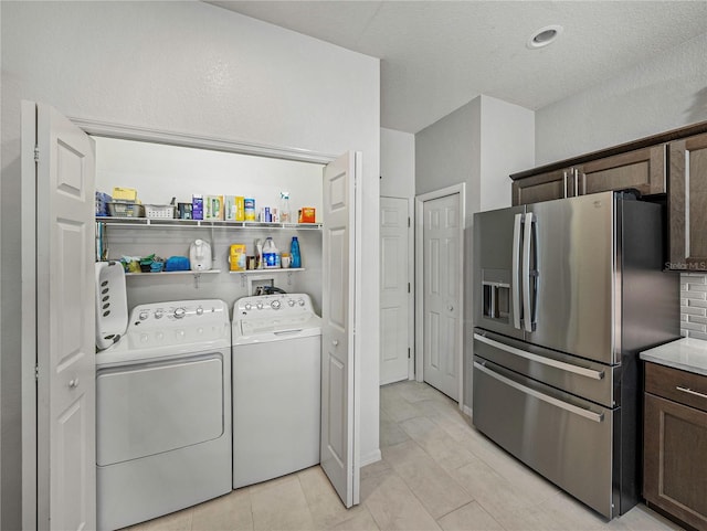 laundry area with light tile patterned flooring and independent washer and dryer