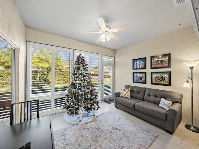 living room with ceiling fan, a healthy amount of sunlight, and light tile patterned floors