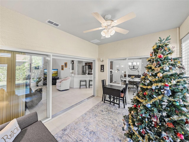 interior space with light tile patterned floors, plenty of natural light, and ceiling fan