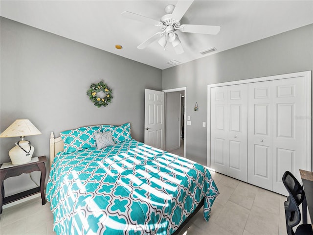 tiled bedroom with a closet and ceiling fan