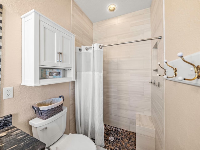 bathroom with a shower with curtain and toilet