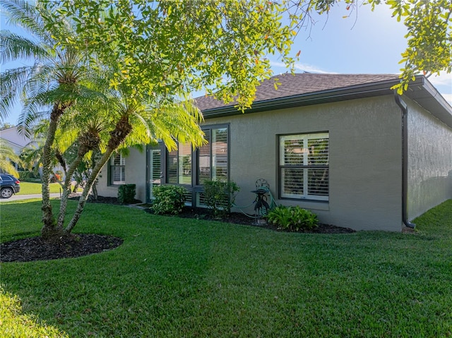 rear view of property with a yard