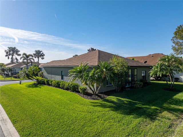 view of side of home featuring a lawn