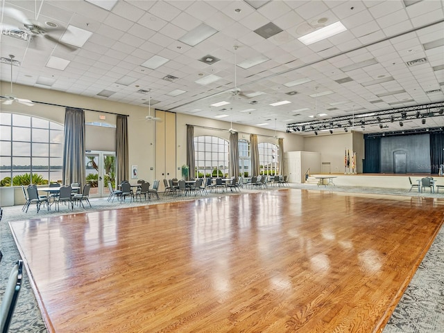 interior space featuring ceiling fan, light hardwood / wood-style floors, and a drop ceiling