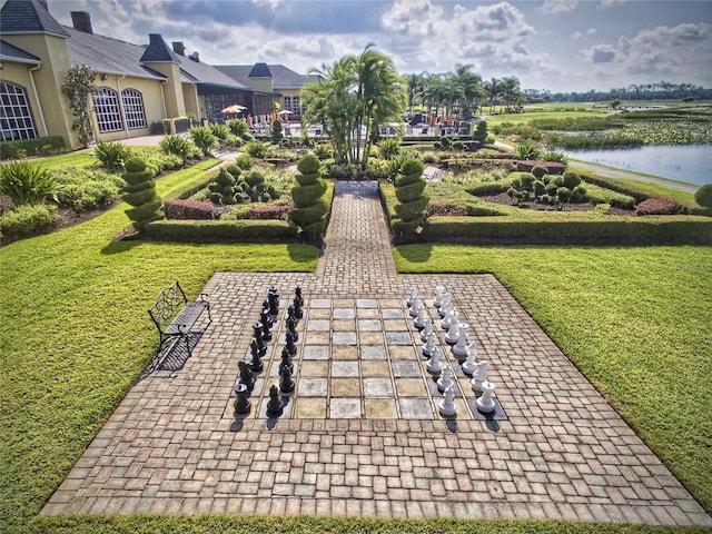 surrounding community featuring a lawn and a water view