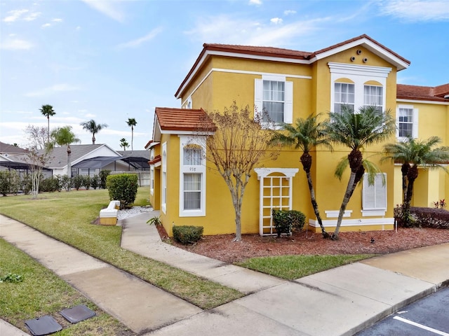 mediterranean / spanish-style house with a front lawn