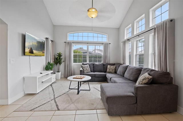 living room with ceiling fan, light tile patterned flooring, and lofted ceiling