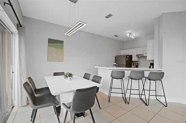 tiled dining room with sink