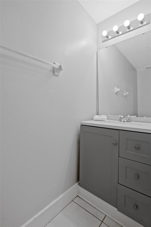 bathroom with tile patterned flooring and vanity