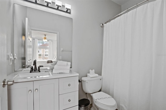 bathroom with vanity, toilet, and ceiling fan