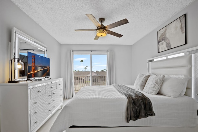 bedroom featuring access to outside, ceiling fan, and a textured ceiling