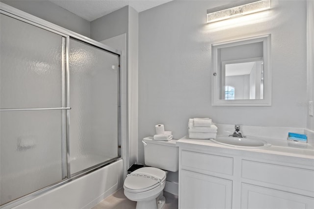 full bathroom featuring combined bath / shower with glass door, toilet, and vanity