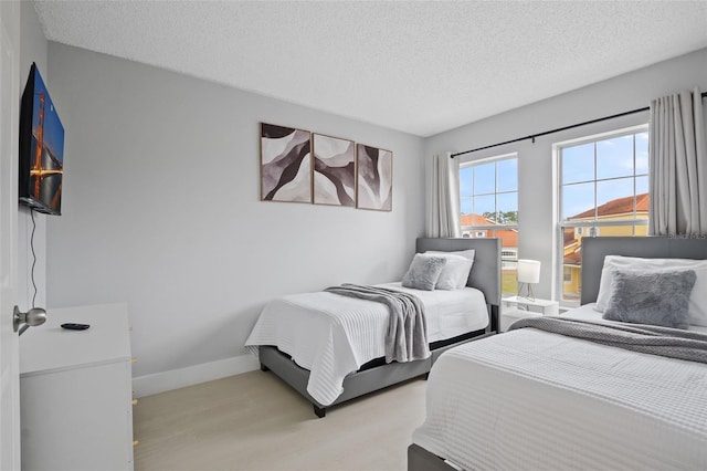 bedroom featuring a textured ceiling and light wood-type flooring