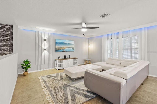 living room featuring ceiling fan and light tile patterned flooring