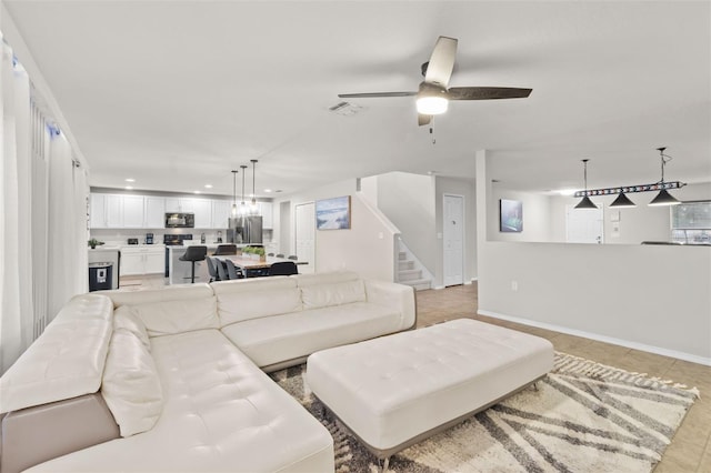 living room with ceiling fan and light tile patterned flooring