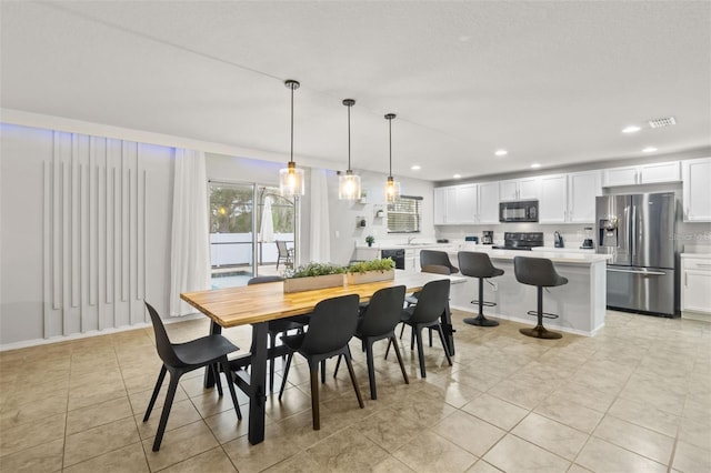 dining area featuring light tile patterned floors