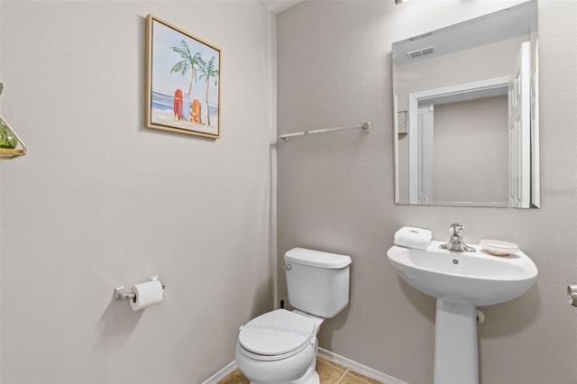 bathroom with tile patterned flooring and toilet