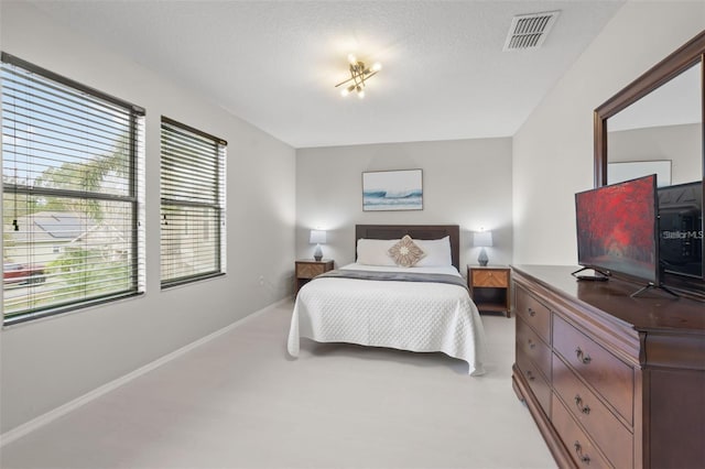 carpeted bedroom with a textured ceiling