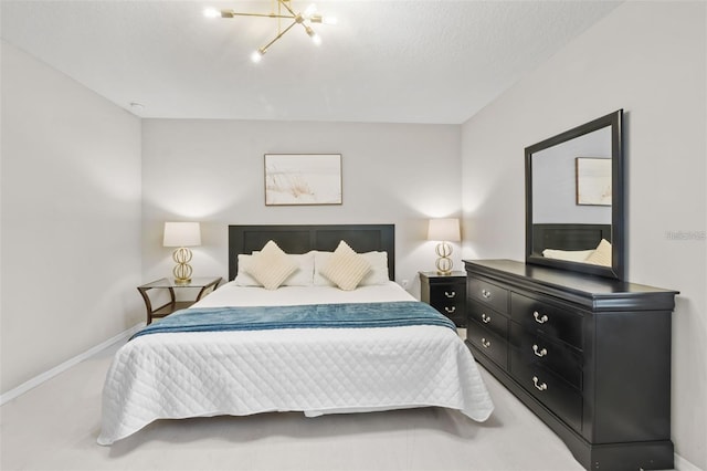 carpeted bedroom featuring a chandelier and a textured ceiling