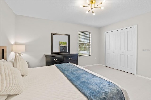 bedroom with carpet, a closet, and a notable chandelier