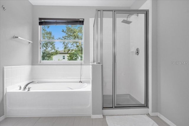 bathroom featuring tile patterned floors and shower with separate bathtub