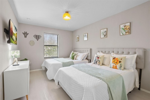 bedroom featuring light carpet