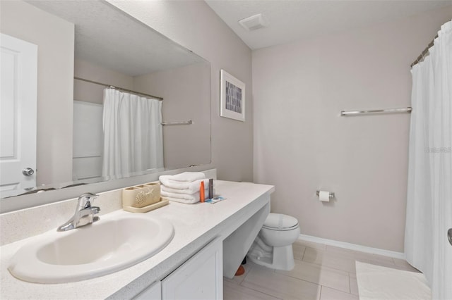 bathroom featuring toilet, vanity, tile patterned floors, and walk in shower