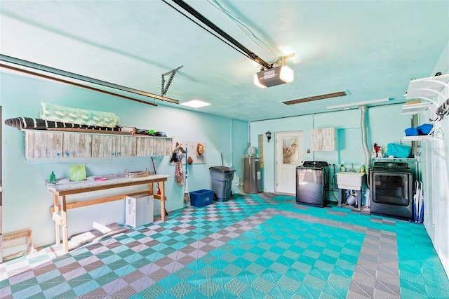 garage with electric water heater, sink, washer and dryer, and a garage door opener