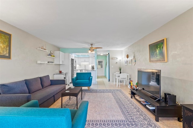 living room featuring ceiling fan and light tile patterned floors