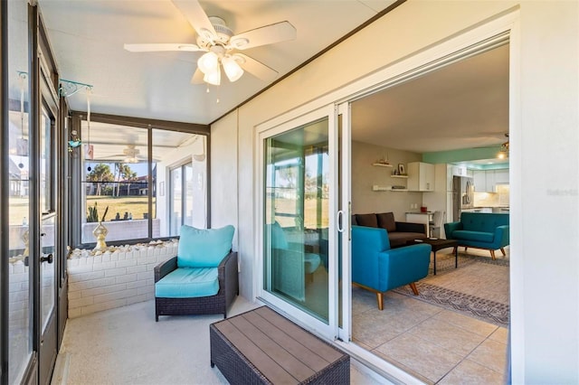 sunroom / solarium featuring ceiling fan and french doors