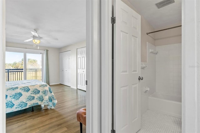 bedroom with ceiling fan, access to exterior, and wood-type flooring