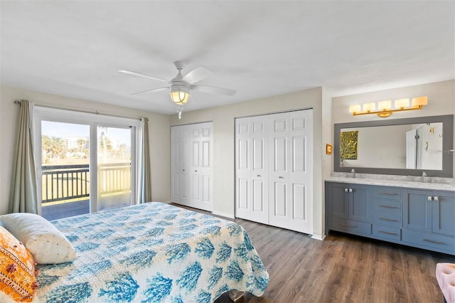 bedroom featuring access to exterior, hardwood / wood-style flooring, ceiling fan, and sink