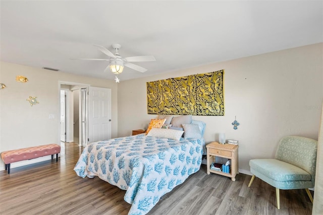 bedroom with ceiling fan and wood-type flooring