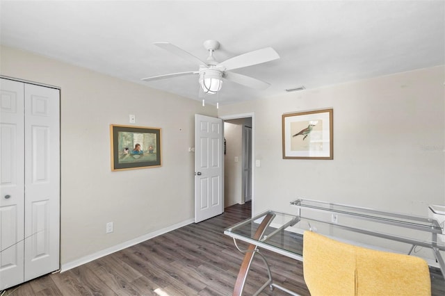 home office featuring dark hardwood / wood-style floors and ceiling fan