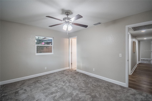 carpeted spare room featuring ceiling fan