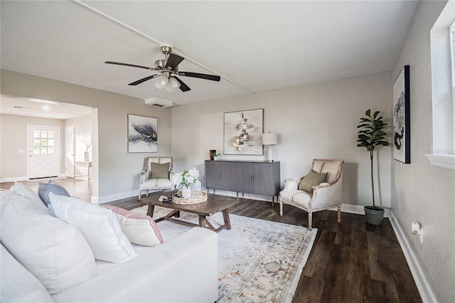 living room with ceiling fan and dark hardwood / wood-style flooring