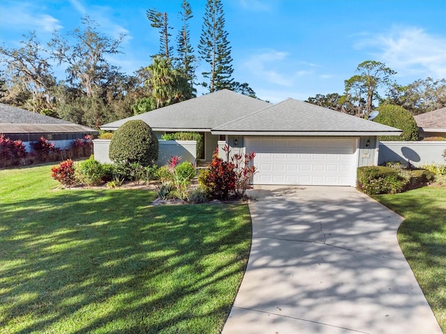 ranch-style house featuring a front lawn and a garage