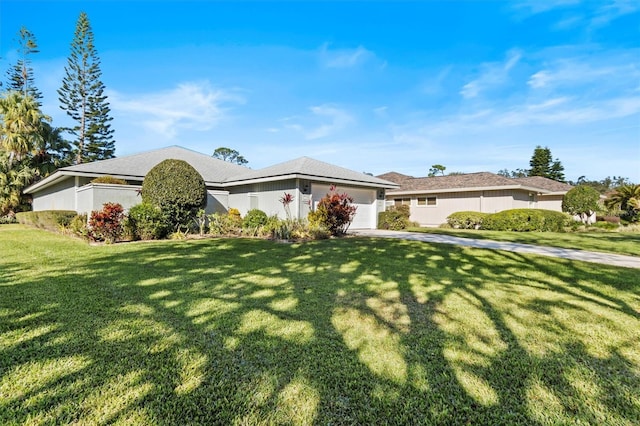 single story home featuring a garage and a front yard