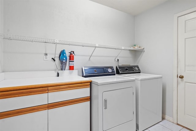 clothes washing area featuring separate washer and dryer and light tile patterned floors