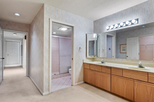 bathroom featuring vanity, toilet, and a shower with door