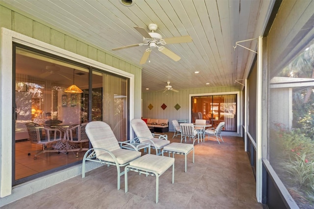 sunroom / solarium with ceiling fan and wood ceiling