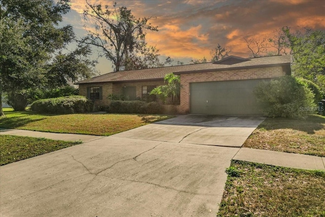 view of front facade featuring a lawn and a garage