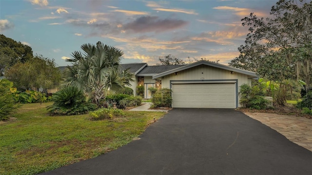 view of front of property with a lawn and a garage