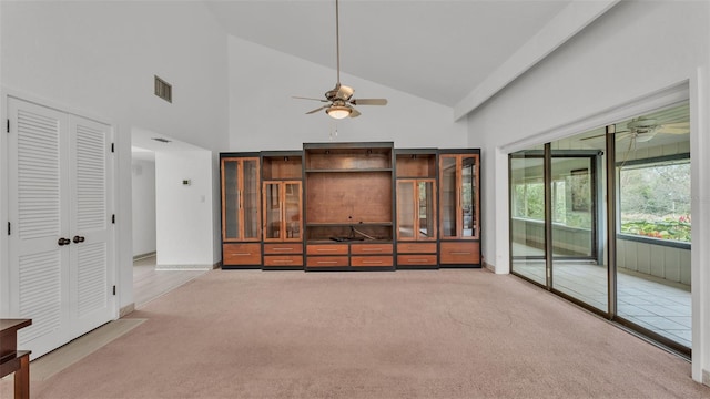 unfurnished living room with light colored carpet, high vaulted ceiling, and ceiling fan