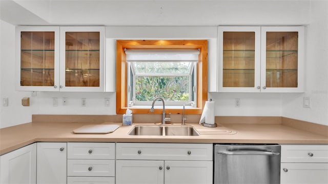 kitchen featuring white cabinetry, stainless steel dishwasher, and sink