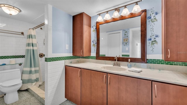 bathroom with a shower with curtain, toilet, tile walls, and vanity