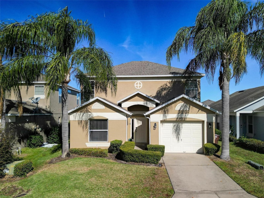 view of front of home featuring a front yard and a garage